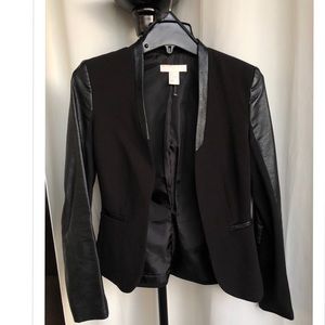 Black blazer with leather sleeves.